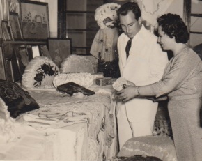 Portuguese crafts teacher shows Mawlana Hazar Imam a collection of needlework prepared by Ismaili students who regularly attended her sessions in a classroom located on the main floor of the Lourenço Marques jamatkhana. Mawlana Hazar Imam visited the Portuguese colonial city in 1959, following a visit made by his beloved father, Prince Aly Khan, in 1958. See photos below. Photo: Jehangir Merchant Collection.